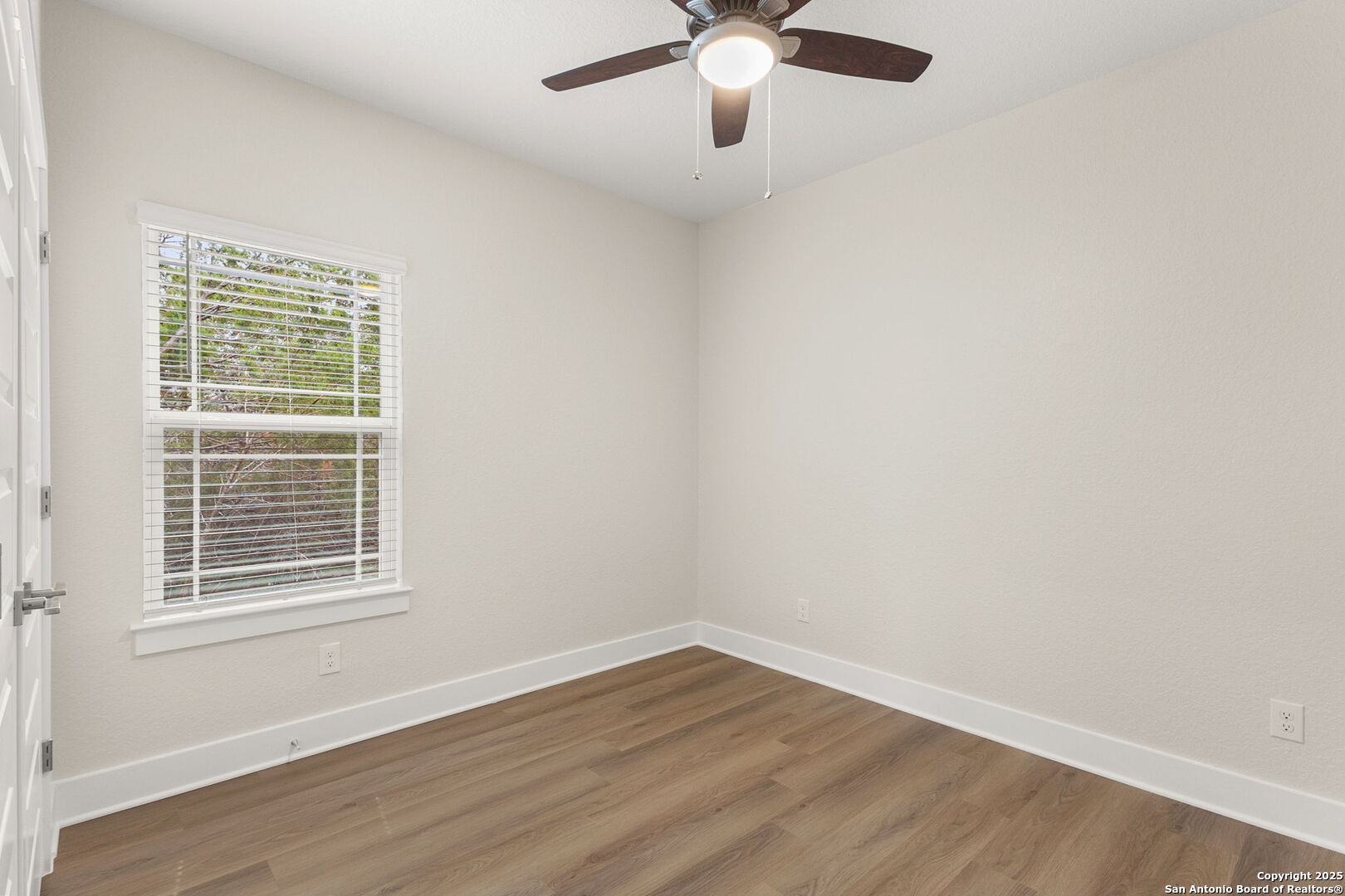 952 Rimrock Cove Spring Branch, TX 78070 - Photo 25 of 39 a view of an empty room with wooden floor and a window