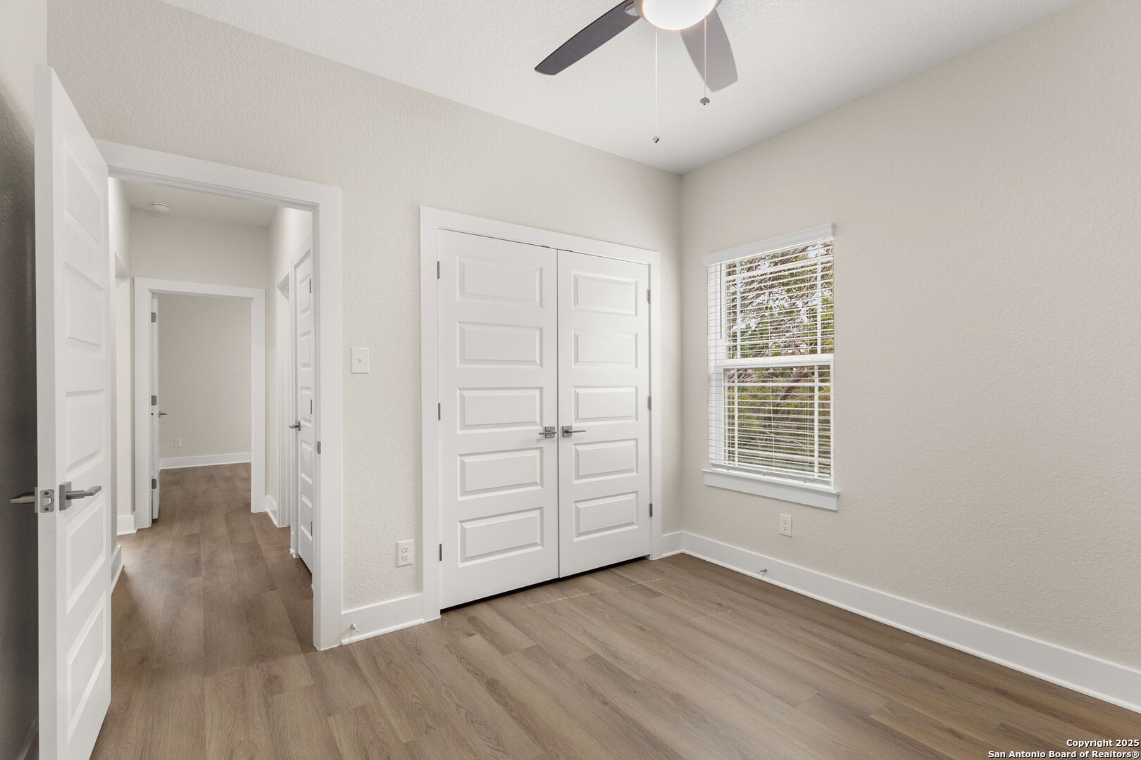 952 Rimrock Cove Spring Branch, TX 78070 - Photo 26 of 39 an empty room with wooden floor cabinet and windows