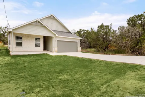 a front view of house with yard and trees