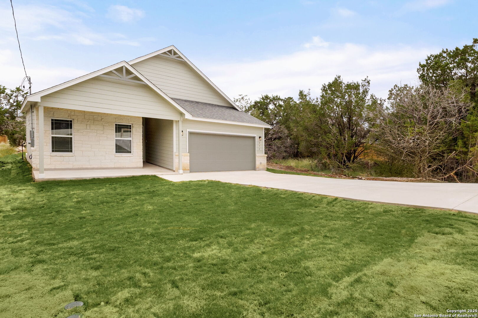 952 Rimrock Cove Spring Branch, TX 78070 - Photo 35 of 39 a front view of house with yard and trees