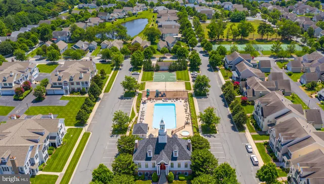 a living room with furniture a chandelier and a large window