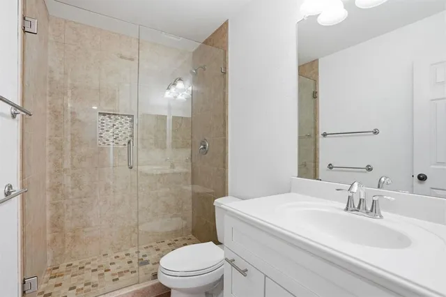 a bathroom with a toilet a sink and mirror