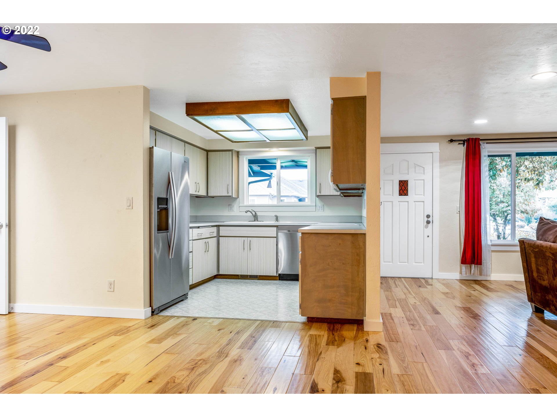 1094 Island Street Springfield, OR 97477 - Photo 8 of 31 a kitchen with stainless steel appliances granite countertop a refrigerator a sink dishwasher and wooden cabinets with wooden floor