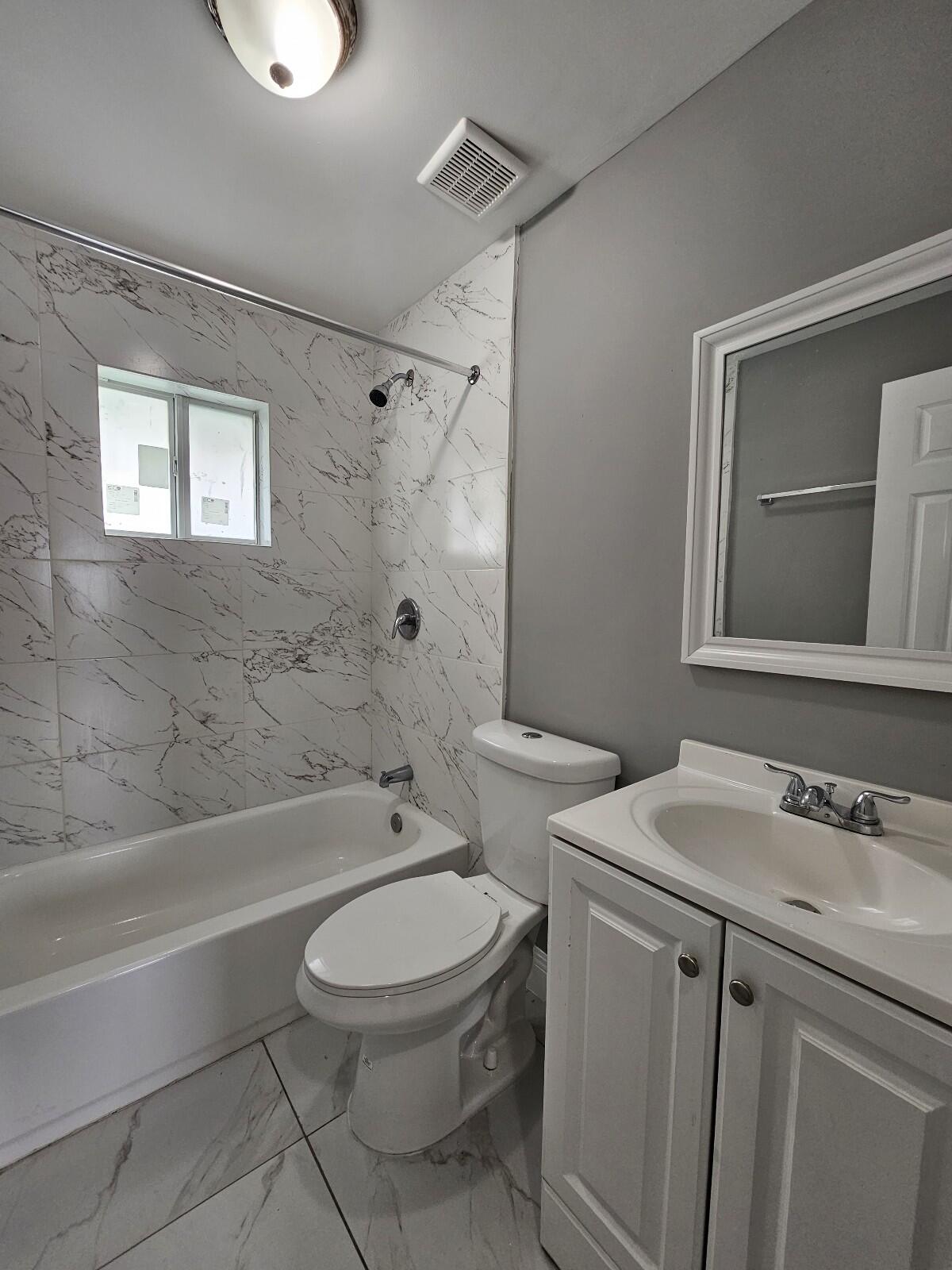 933 West 7th Street, Unit C Riviera Beach, FL 33404 - Photo 8 of 16 a bathroom with a sink toilet and shower