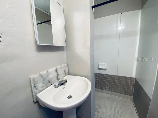 a bathroom with a sink and a mirror