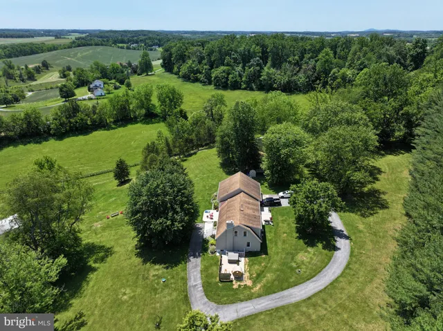 an aerial view of a house with a yard