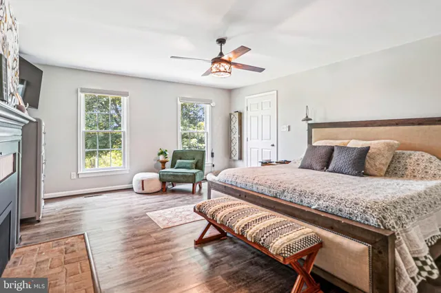 a spacious bedroom with a bed a couch and a window