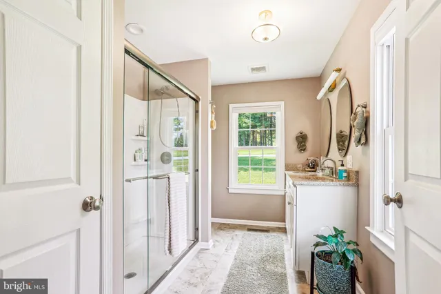a view of hallway with furniture and a potted plant