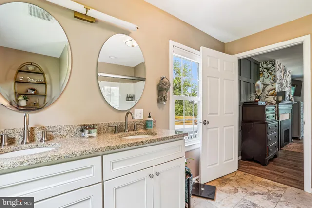 a bathroom with a double vanity sink and a mirror