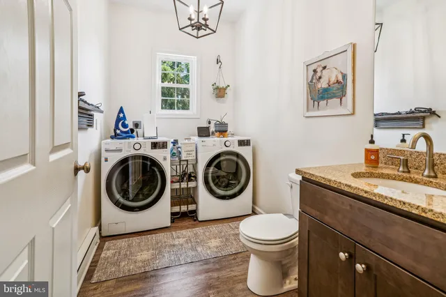 a bathroom with a toilet a sink and mirror
