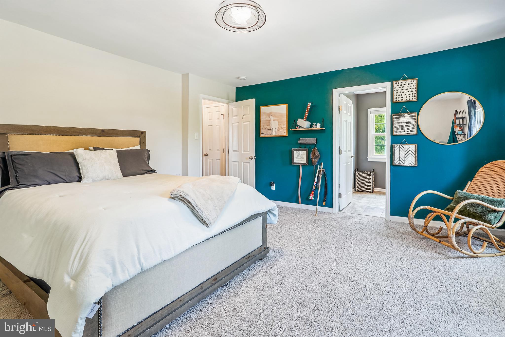 8730 Mapleville Road Union Bridge, MD 21791 - Photo 25 of 50 a bedroom with a bed and a lamp on dresser next to a window