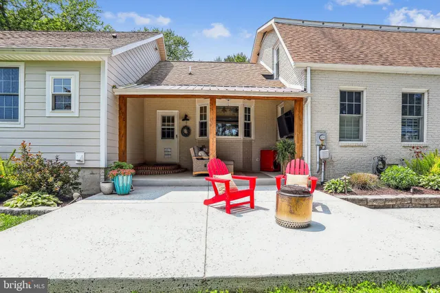 a backyard of a house with outdoor seating