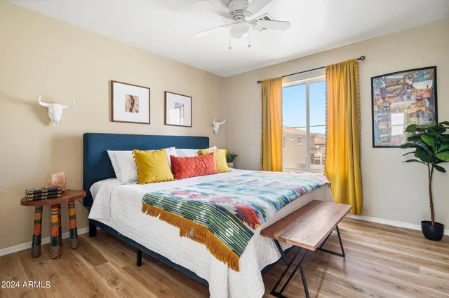 a bedroom with bed and wooden floor