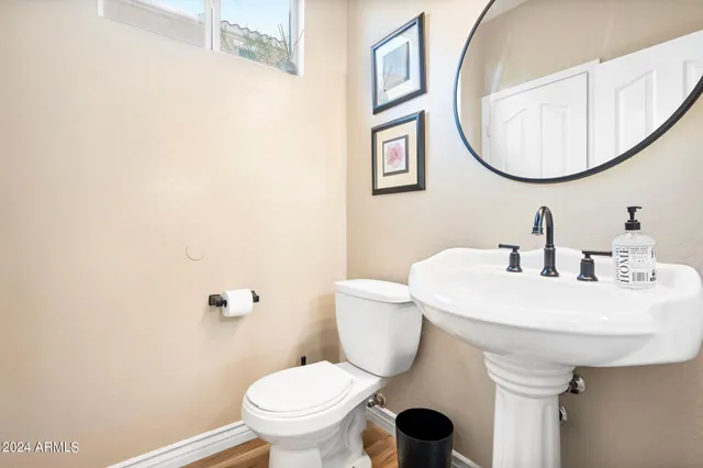 a bathroom with a sink toilet and a mirror