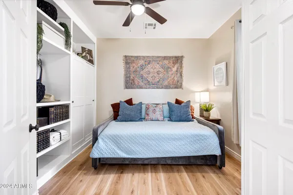a bedroom with a bed and a book shelf