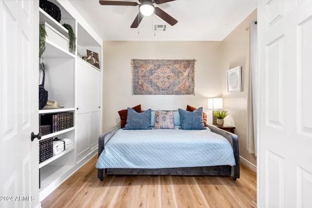 a bedroom with a bed and a book shelf