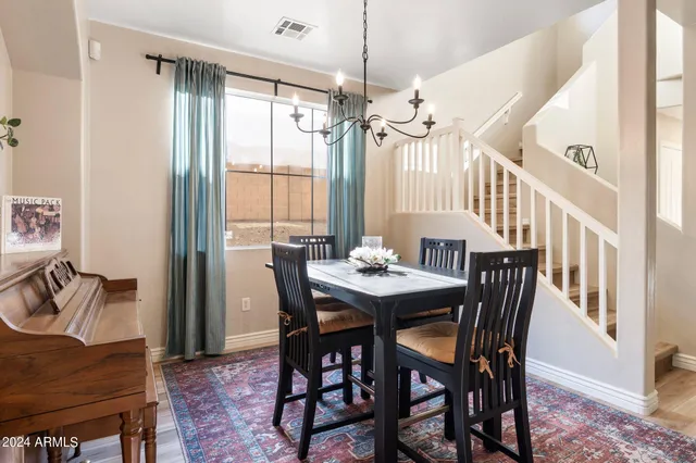 a view of a a dining room with furniture window and wooden floor