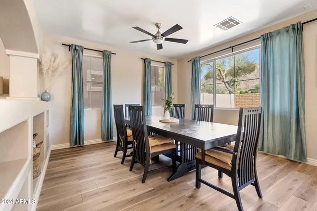 a view of a dining room with furniture window and wooden floor