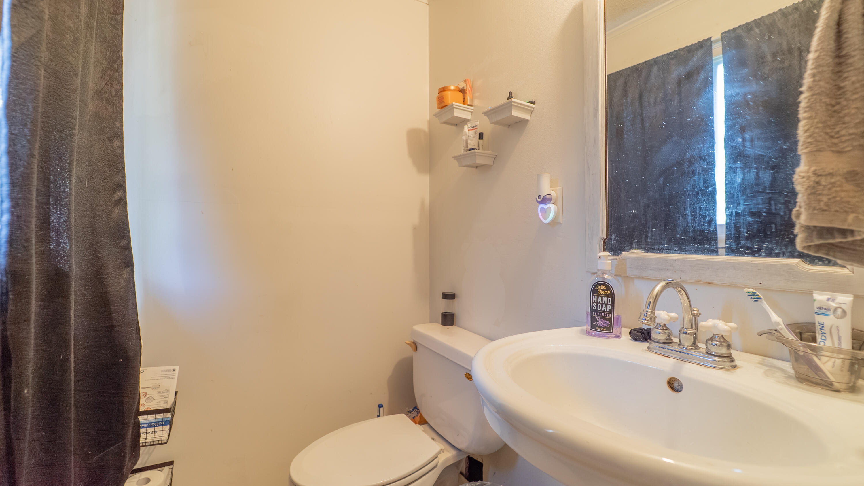 629 West South Street Crown Point, IN 46307 - Photo 11 of 23 a bathroom with a sink mirror and toilet