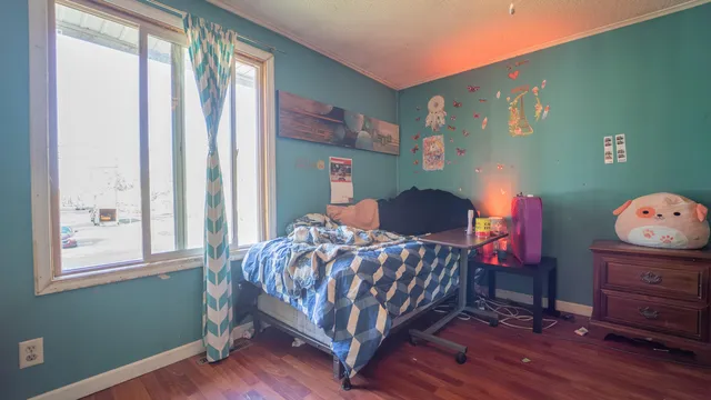 a bedroom with a bed and a window
