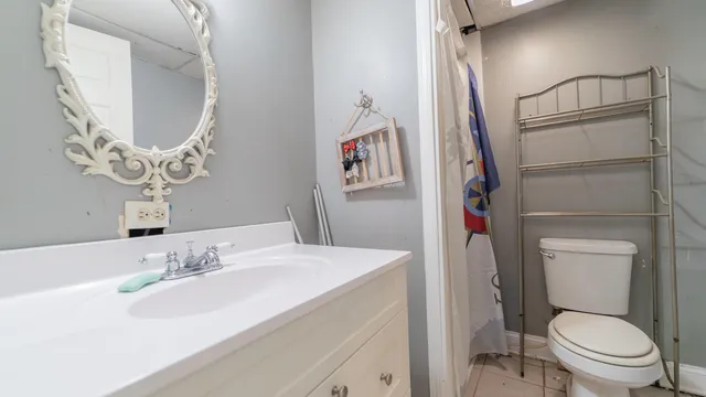 a bathroom with a toilet a sink and a mirror