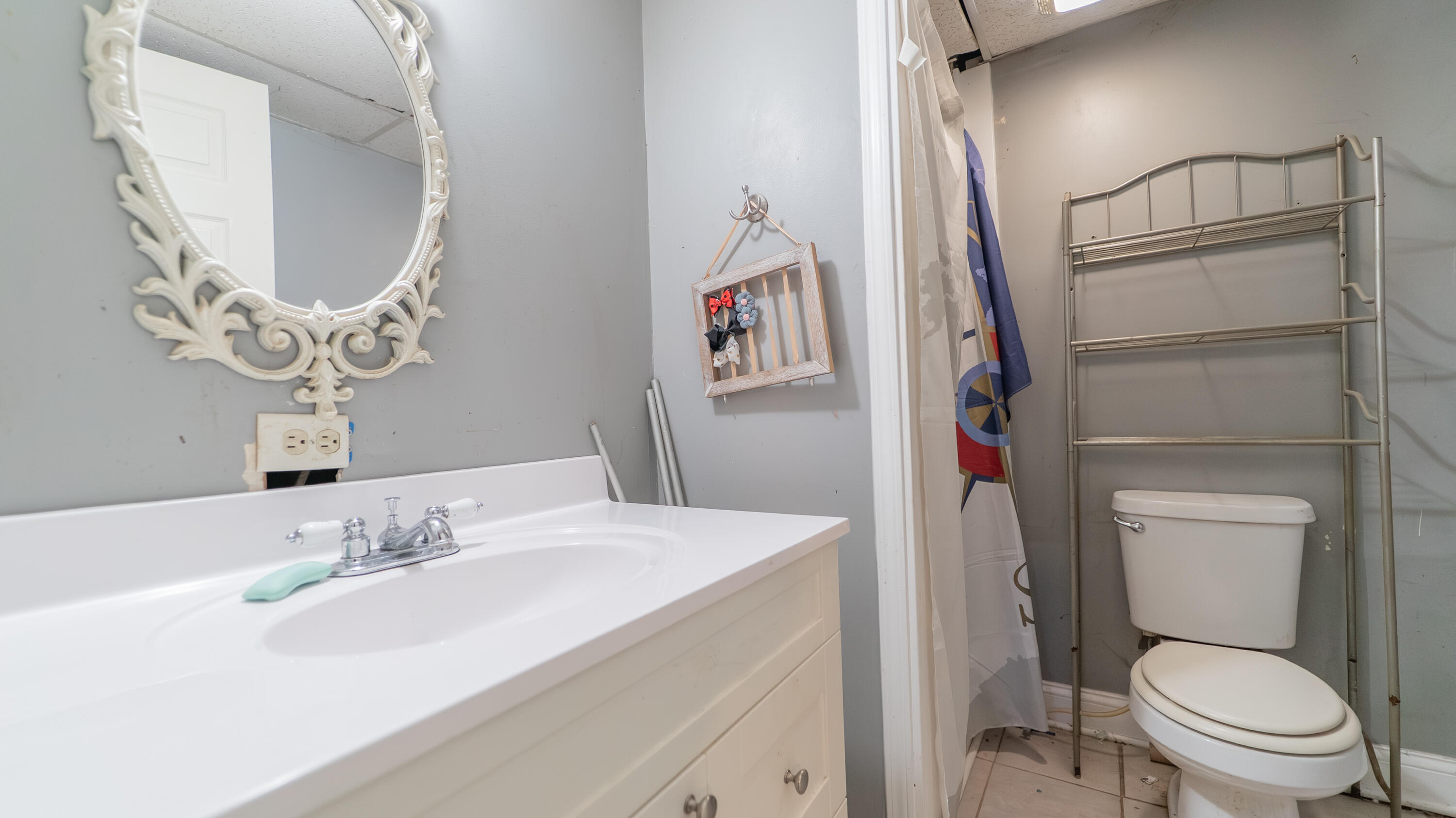 629 West South Street Crown Point, IN 46307 - Photo 10 of 23 a bathroom with a toilet a sink and a mirror
