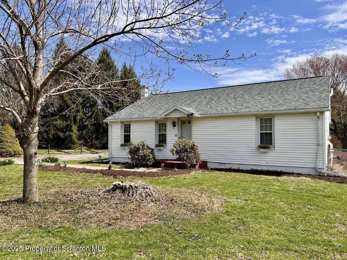 4 East Lemon Road Tunkhannock, PA 18657 - Photo 1 of 25 a backyard of a house with yard and outdoor seating