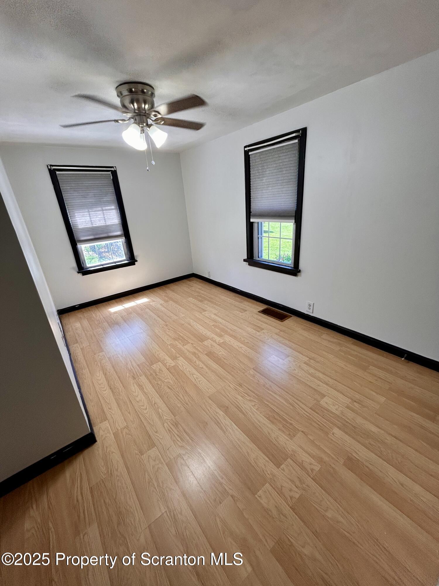 4 East Lemon Road Tunkhannock, PA 18657 - Photo 15 of 25 a view of an empty room with wooden floor and a window