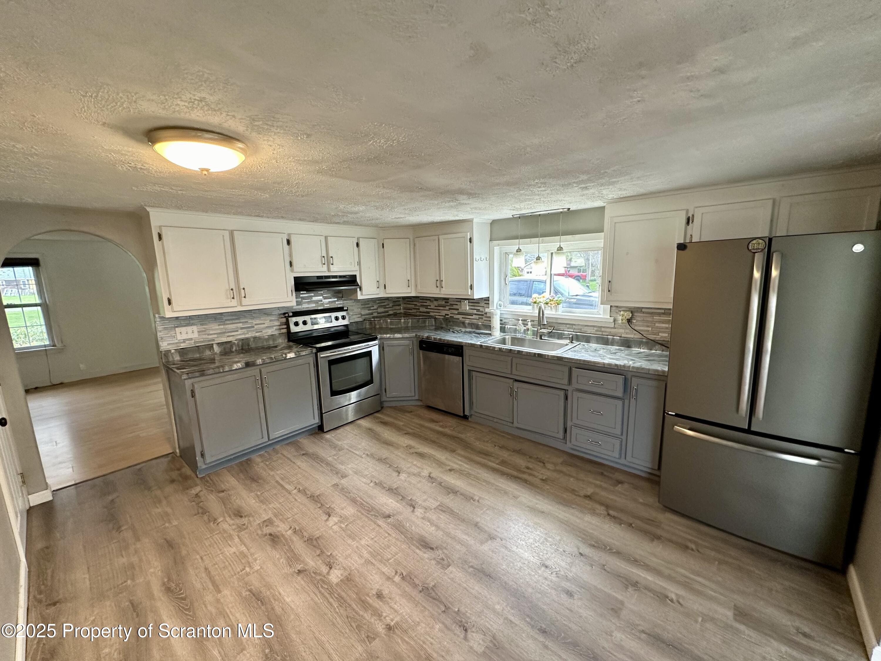 4 East Lemon Road Tunkhannock, PA 18657 - Photo 5 of 25 a kitchen with granite countertop stainless steel appliances and wooden cabinets