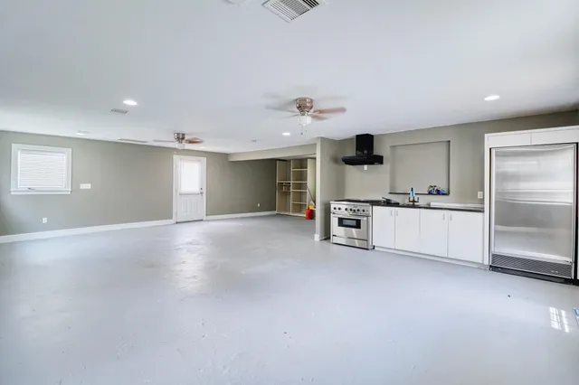 a view of a kitchen with refrigerator and cabinets