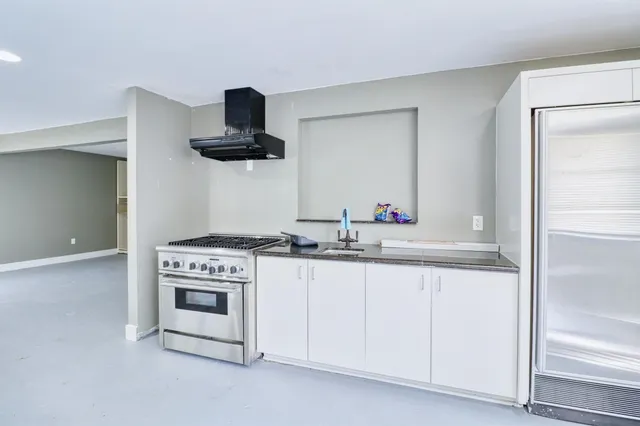 a kitchen with granite countertop a sink and a stove