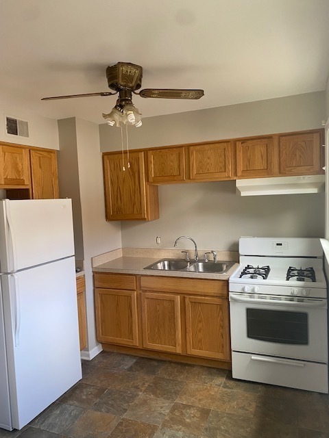 809 Vine Street Joliet, IL 60435 - Photo 5 of 8 a kitchen with stainless steel appliances a stove a sink and a refrigerator