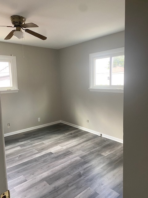 809 Vine Street Joliet, IL 60435 - Photo 8 of 8 wooden floor in an empty room with a window