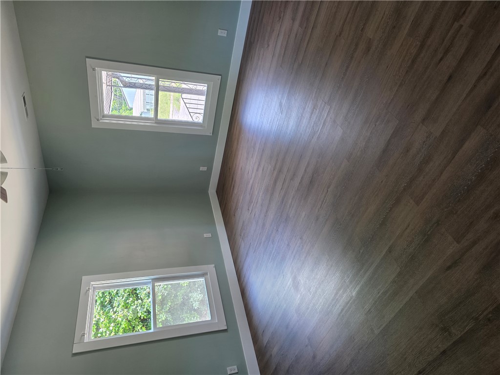 112 Simmons Street Anderson, SC 29625 - Photo 16 of 26 Hardwood-style flooring and soaring ceilings characterize this inviting living space.