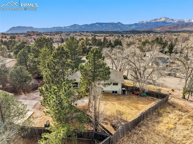 a view of a house with a yard and mountain view