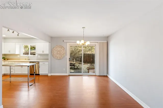 a view of a living room and kitchen with a large window