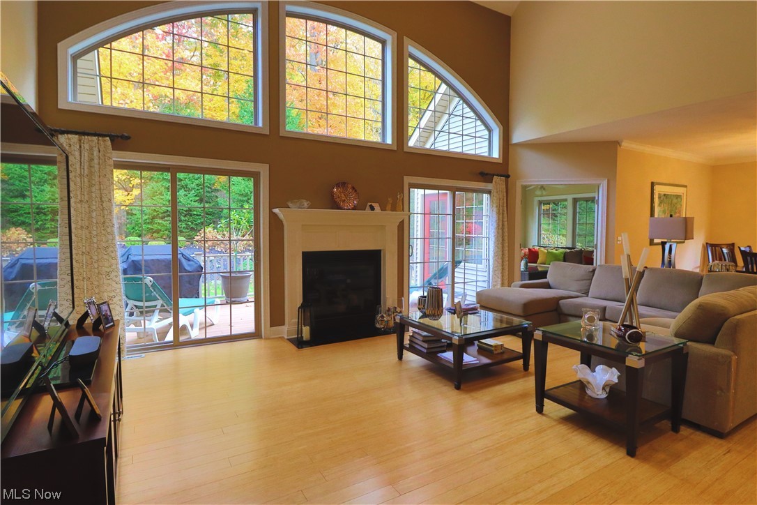 8257 Morley Road Mentor, OH 44060 - Photo 12 of 35 Great room with bamboo wood flooring, crown molding, a high ceiling, and a healthy amount of sunlight