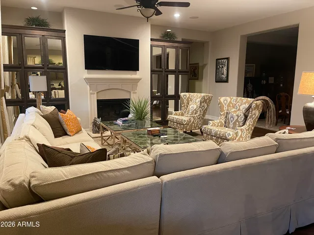 a living room with furniture fireplace and flat screen tv