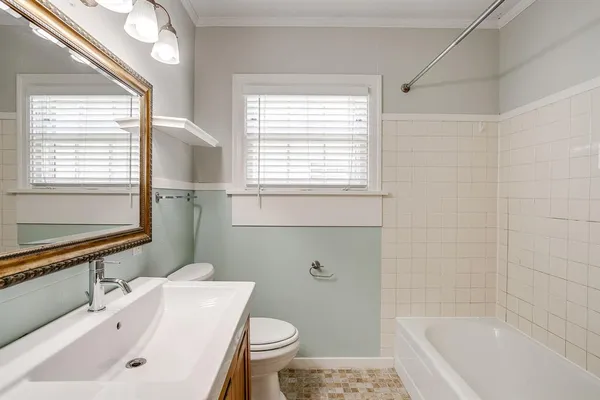 a bathroom with a sink a toilet and bathtub