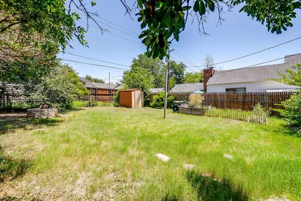 a backyard of a house with yard and outdoor seating