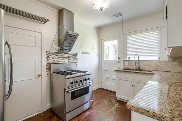 a kitchen with a stove a sink and a refrigerator