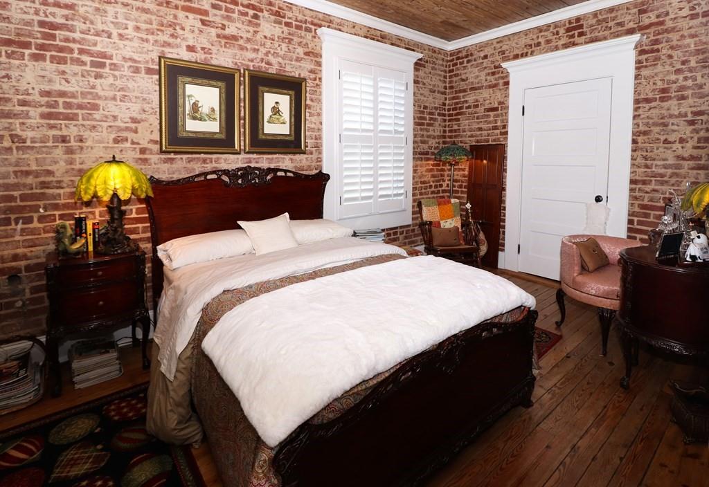 114 North 3rd Avenue Chatsworth, GA 30705 - Photo 24 of 59 a bed sitting in a bedroom next to a window with chair