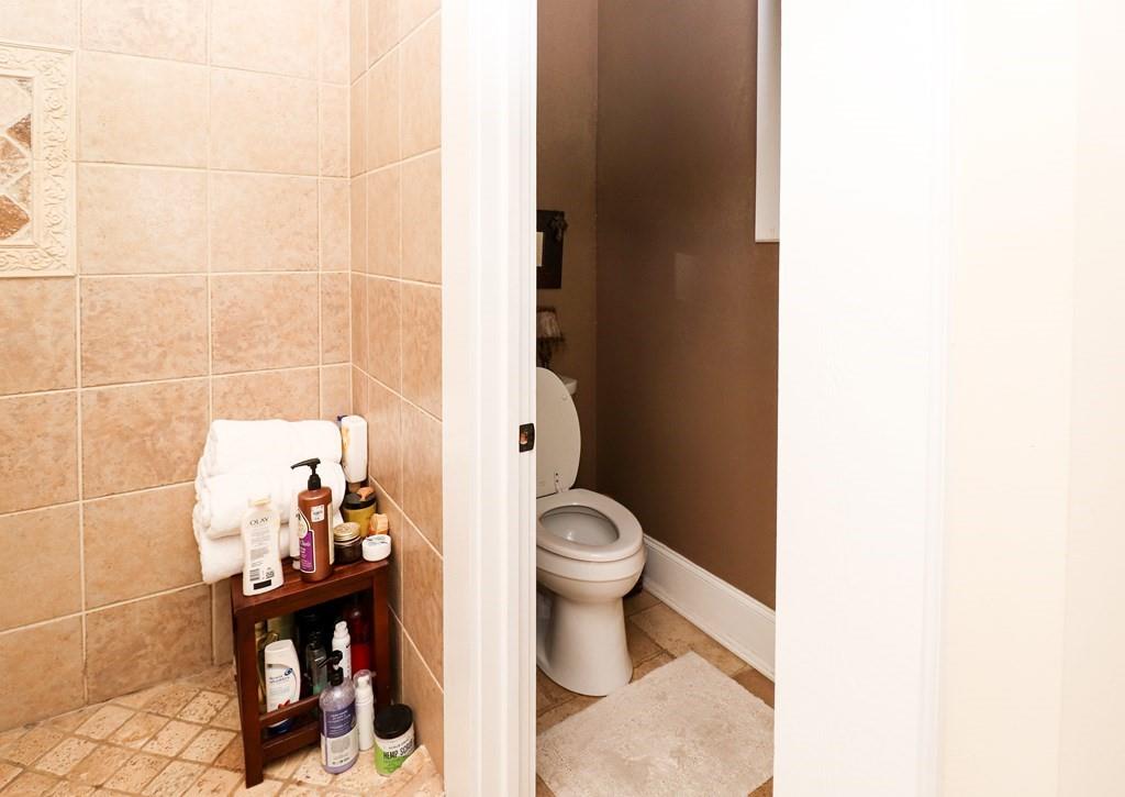 114 North 3rd Avenue Chatsworth, GA 30705 - Photo 35 of 59 a bathroom with a toilet and a shower curtain