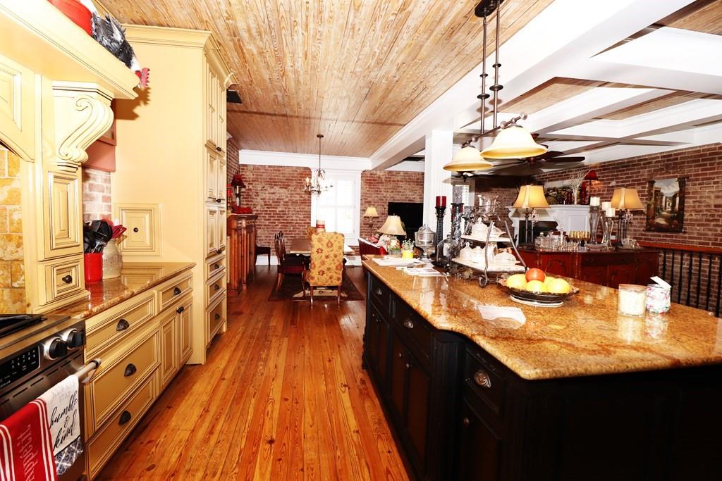114 North 3rd Avenue Chatsworth, GA 30705 - Photo 10 of 59 a kitchen with stainless steel appliances granite countertop a sink and wooden floors