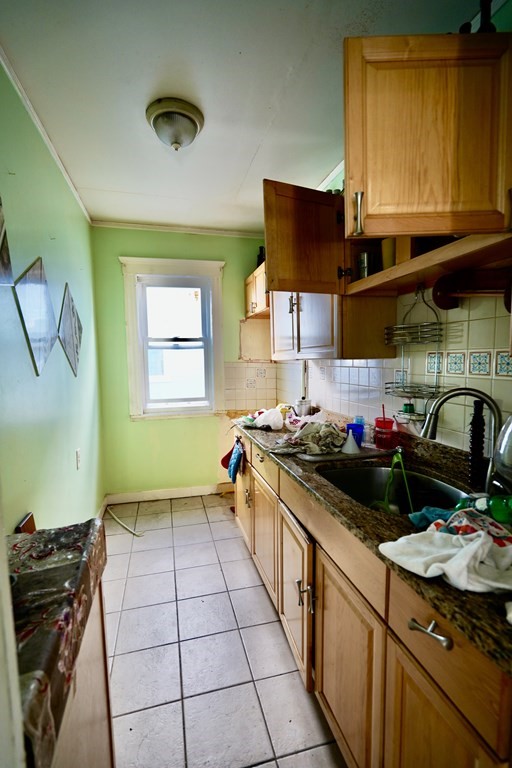 298 Lawrence Street Lawrence, MA 01841 - Photo 12 of 42 a kitchen with a stove and a sink
