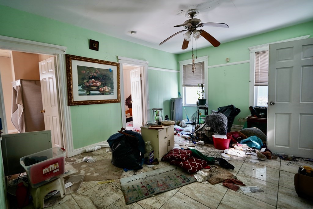 298 Lawrence Street Lawrence, MA 01841 - Photo 13 of 42 a room with furniture and a fan