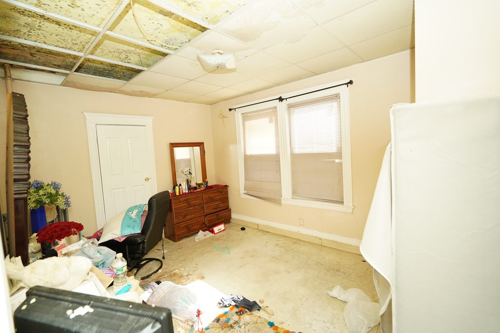 298 Lawrence Street Lawrence, MA 01841 - Photo 15 of 42 a bedroom with a bed and wooden floor