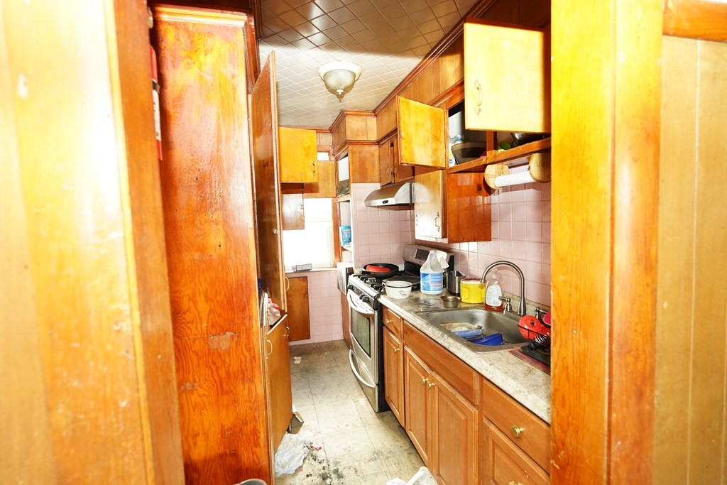 298 Lawrence Street Lawrence, MA 01841 - Photo 19 of 42 a kitchen with sink cabinets and appliances