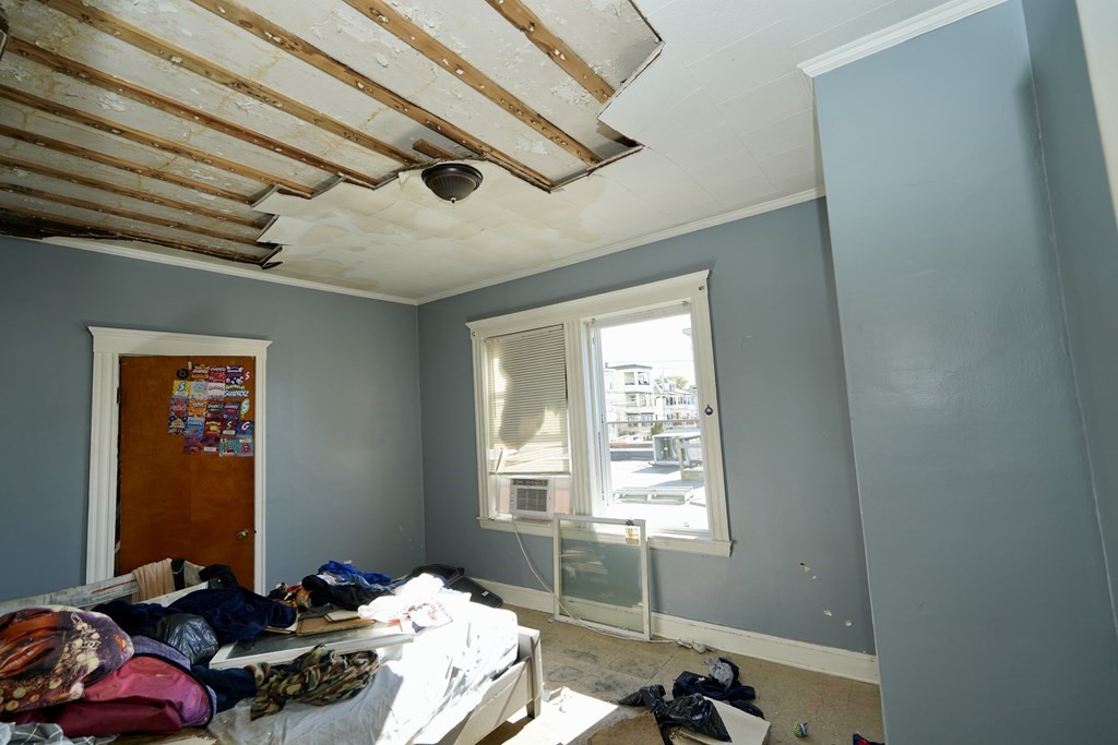 298 Lawrence Street Lawrence, MA 01841 - Photo 21 of 42 a bed room with furniture and a window