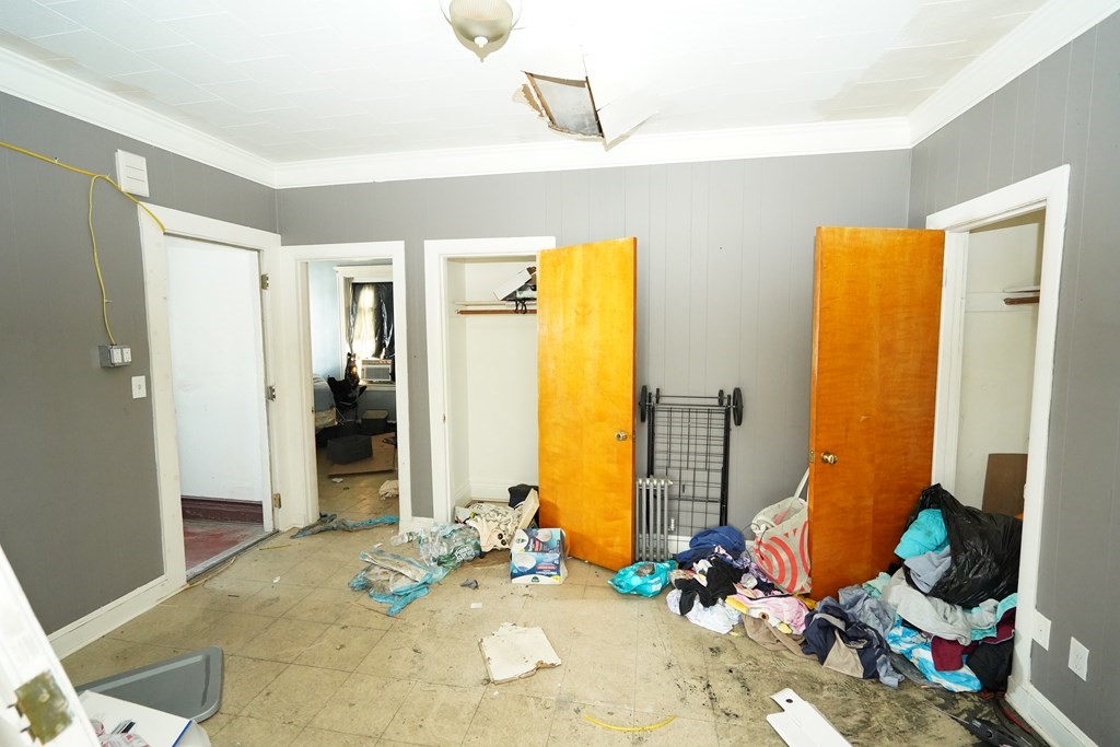 298 Lawrence Street Lawrence, MA 01841 - Photo 25 of 42 a bedroom with a bed and wooden floor